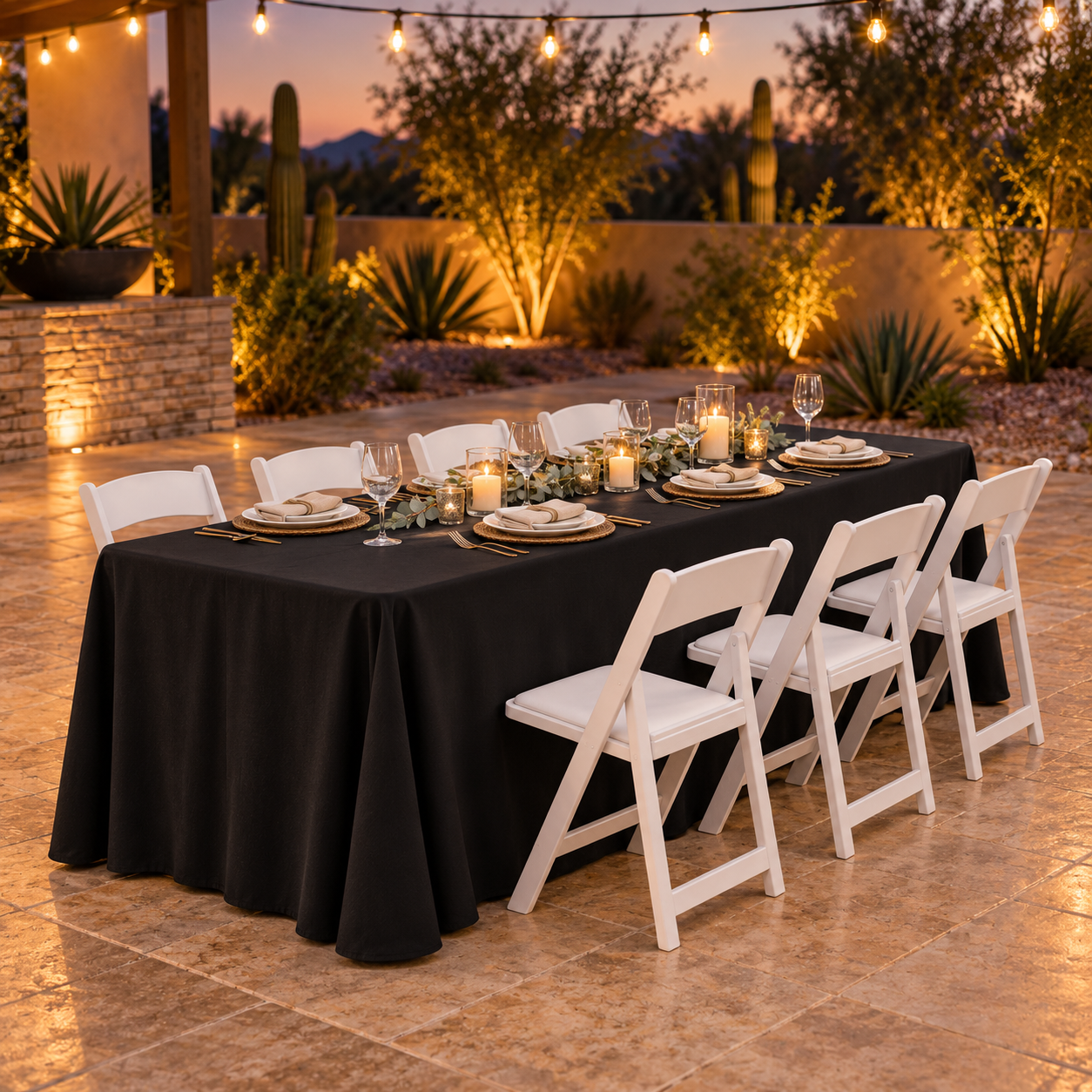8-foot rectangular table with a black floor-length linen and EventRent AZ white folding chairs at an Arizona evening event