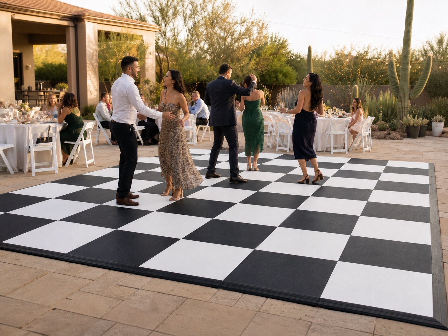 Guests dancing on a black-and-white checkered dance floor at a polished Arizona event