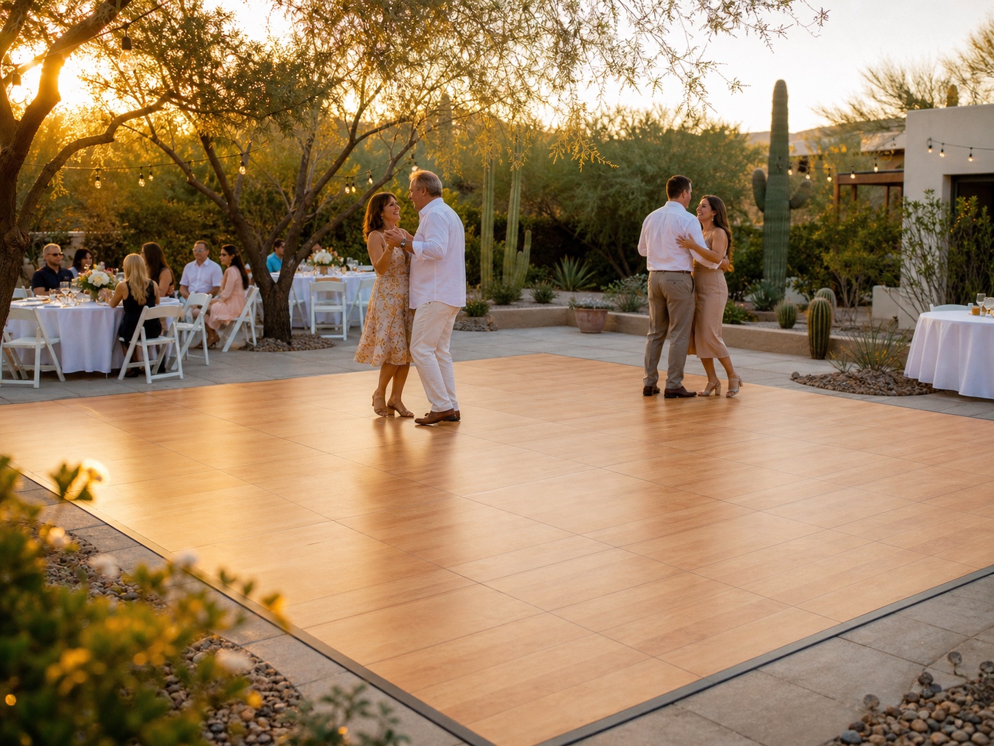 Guests dancing on a professionally installed warm maple-look dance floor at an Arizona outdoor event